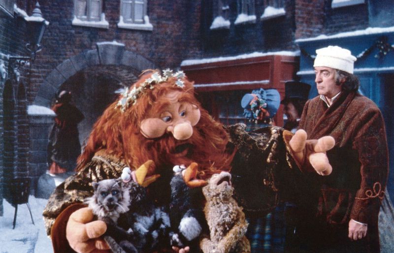 The Ghost of Christmas Present, left, and Michael Caine, right, in 1992's "The Muppet Christmas Carol."