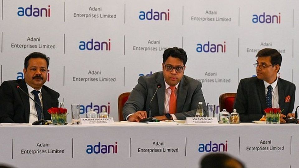 Adani Enterprises group board members (L-R) executive vice president Raghwendra Pande, corporate finance head Anupam Misra (C) and head of finance of Adani airport Rakesh Tiwari attend a news conference on the FPO