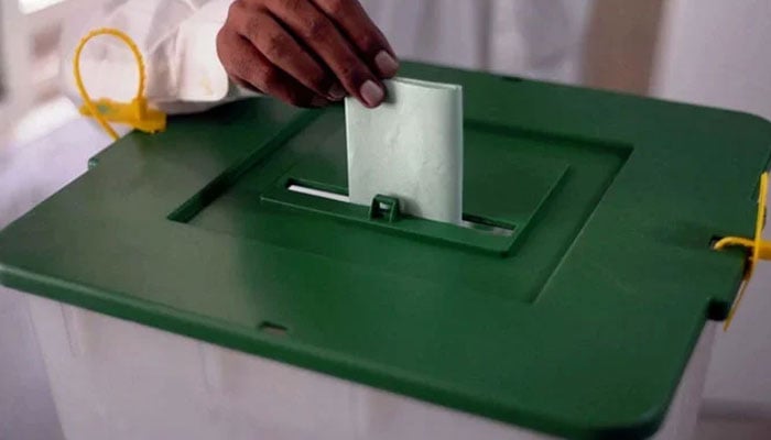 A voter is casting his vote at a polling station during by-elections in the NA-237 constituency in Karachi on October 16, 2022. — PPI