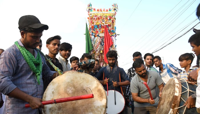 Muslim mourners take part in a procession on the tenth day of Ashura during the Islamic month of Muharram, commemorating the seventh-century martyrdom of Prophet Mohammads (PBUH) grandson Hazrat Imam Hussain (RA) in Karachi on July 28, 2023. — Online