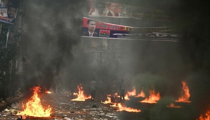 Bangladesh Nationalist Party (BNP) activists light fire during a rally demanding the resignation of Prime Minister Sheikh Hasina and the release of BNP Chairperson Begum Khaleda Zia, in Dhaka, Bangladesh on October 28. — AFP