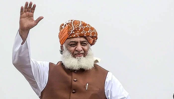 Maulana Fazlur Rehman waves to a crowd at a rally. — AFP/File