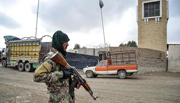 A Taliban security personnel stands guard at the Afghanistan-Pakistan border in Spin Boldak on December 12, 2022. — AFP