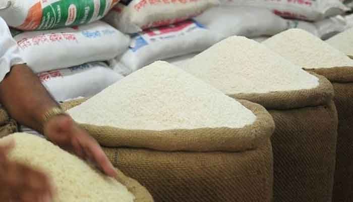 This picture shows an Indian shopkeeper selling basmati rice. — AFP/File