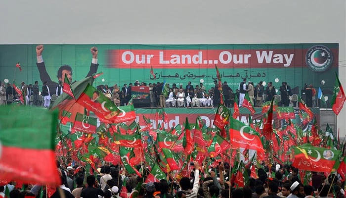 Pakistan Tehreek-e-Insaaf (PTI) activists wave party flags during a rally in Peshawar. — AFP/File