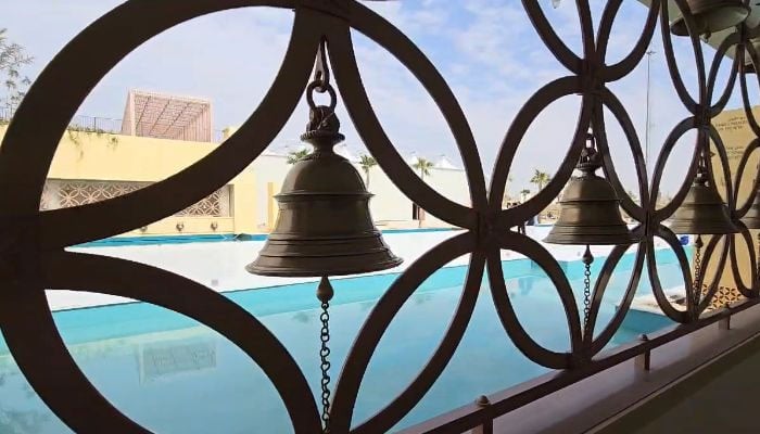 A photograph of decorative bells adorning the temples structure. — Photo by author