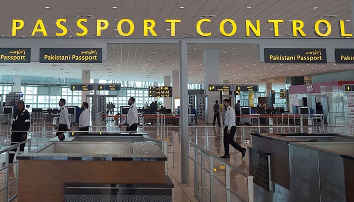 Airport officials walk past the passport control area in the Islamabad International Airport. — AFP/File