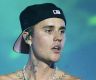 Justin Bieber flys solo at Coachella while Hailey stuns at Revolve Festival