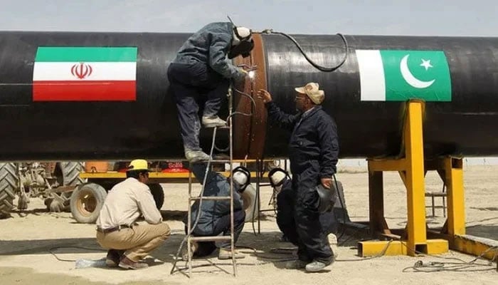 Workers can be seen busy working on a gas pipeline at Chah Bahar, Iran. — AFP/File