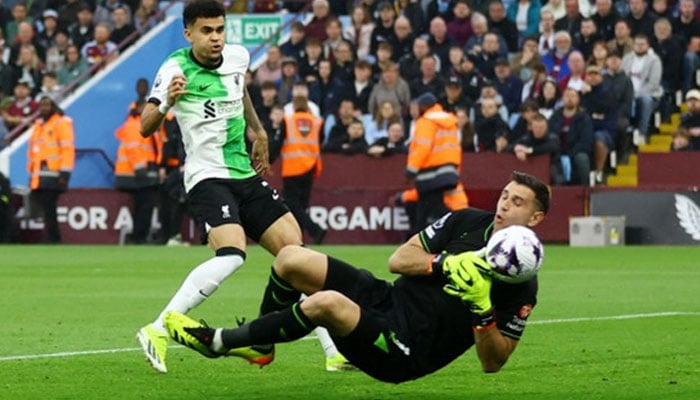 Aston Villa goalkeeper Emiliano Martínez attempts to block a cross from Liverpool midfielder. — Reuters File