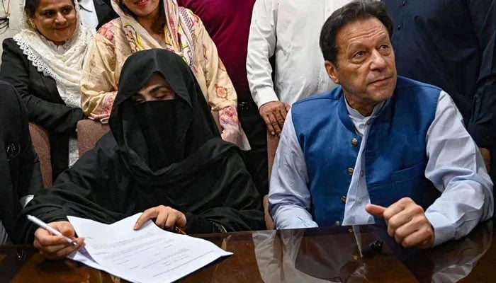 PTI founder Imran Khan (right) pictured alongside his wife Bushra Bibi at registrars office in the High court, in Lahore on July 17, 2023. — AFP