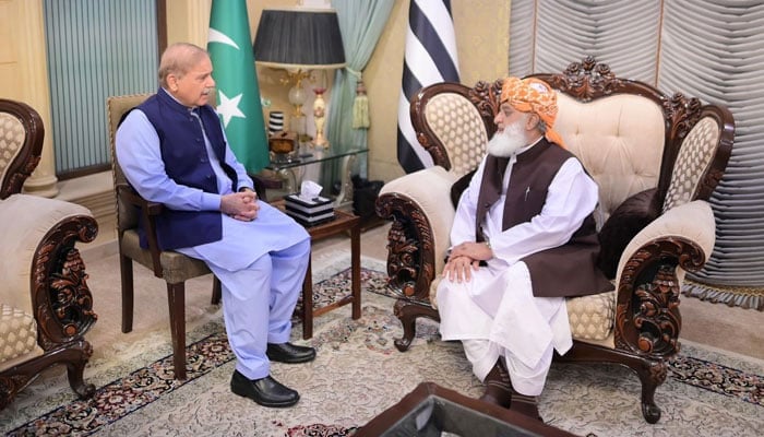 Prime Minister Shehbaz Sharif (left) is seated with JUI-F chief Maulana Fazlur Rehman at his residence in Islamabad on June 13, 2024. — PMO