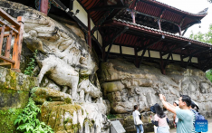 Tourists visit scenic spot of Dazu Rock Carvings in China's Chongqing